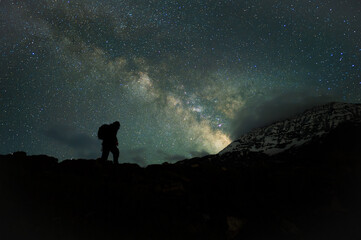 Fototapeta premium Stargazing Human in Universe, a boy under milky way, Himalayas, Stars, mountain, snow, Lahaul, Himachal Pradesh, India, 