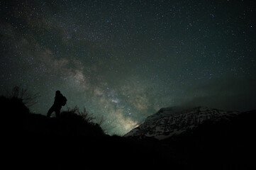 Fototapeta premium Stargazing Human in Universe, a boy under milky way, Himalayas, Stars, mountain, snow, Lahaul, Himachal Pradesh, India, 