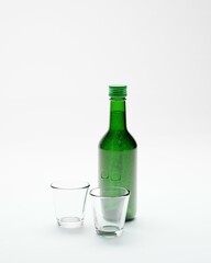 3d render of isolated korean soju bottles and glasses alcohoc beverage