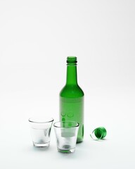 3d render of isolated korean soju bottles and glasses alcohoc beverage
