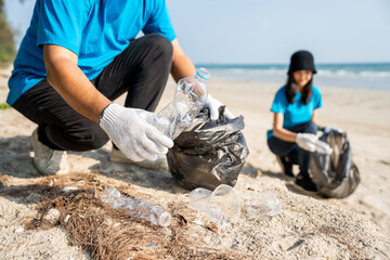 Group teamwork volunteer pick up the plastic bottle on the beach. People male and female Volunteer...