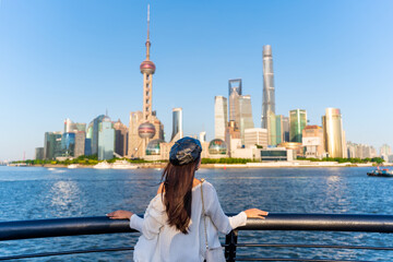 Young female tourist relaxing and looking beautiful modern city at Shanghai, China