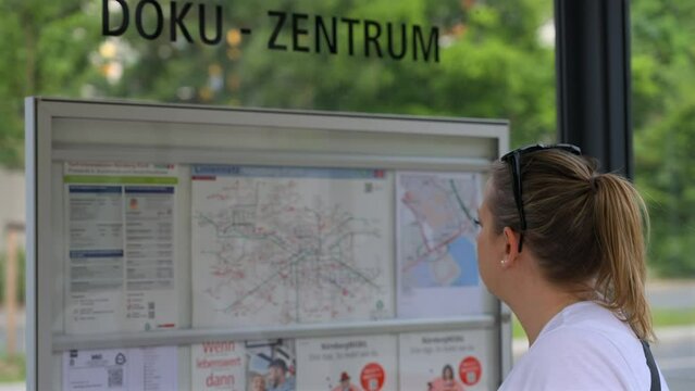 Female reading a train map in Germany, Slowed to half speed
