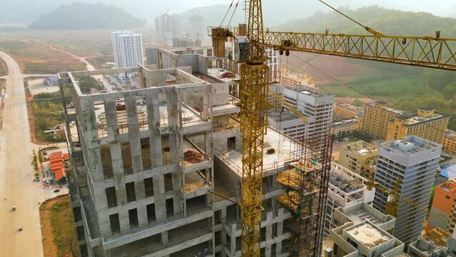 Slow rising shot revealing buildings being constructed in Boten Special Economic Zone