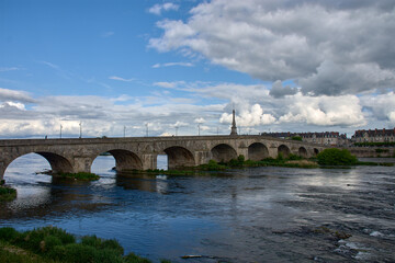 Fototapeta premium Cityscape with old stone bridge across Loire river in Blois, France