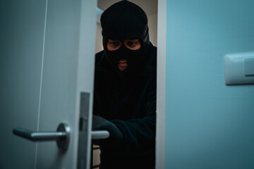 Thief in uniform black jacket various action housebreak. The Robber terrorism criminal escapes with balaclava and crowbar entering a house for stealing Housebreak at night