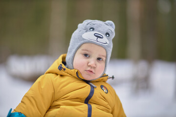 The Little Explorer in a Yellow Jacket and Gray Hat