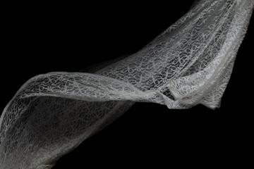 White lace fabric flying in curve shape, Piece of textile white lace fabric throw fall in air....