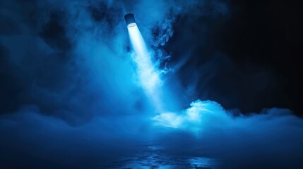 Obraz premium Showcase the dramatic allure of your products with an image featuring a blue vector spotlight projecting through smoke volume light effects against a dark backdrop, resembling the atmospheric.