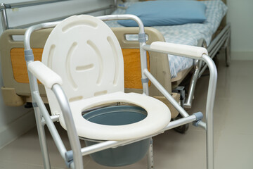 Flush toilet and shower chair in bathroom for old elder people.