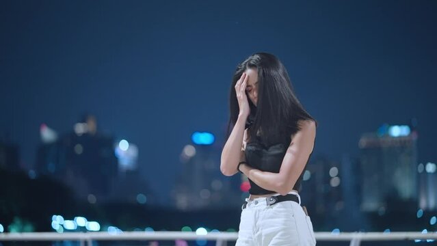 Shot of young asian girl standing alone by the river with evening environment, showing disappointed face, heart broken things does not goes as planned, sad and despair lonely girl in big city