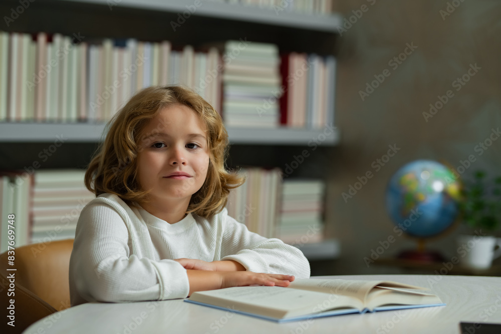 Aufkleber Child at school. Schoolboy reading book in library. Kids development. Pupil learn to read. Child from elementary school read books in a book store.