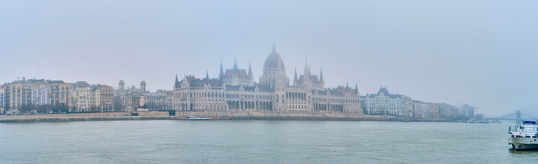 Fototapeta premium Panorama of Pest side with Parliament building in morning fog, Budapest, Hungary