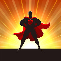 Superhero Silhouette in Red Cape Standing in Rays of Light