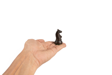 Black male hand holding a black wooden chess horse figure isolated cutout no background