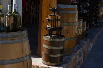 Retro-style wine press among wooden barrels at the winery (without trademarks) (Rhodes, Greece)