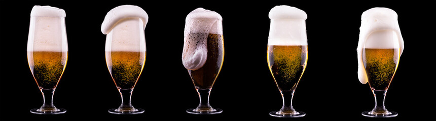 Frosty glass of light beer on black background