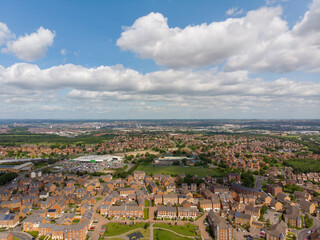 Aerial drone photo over looking the area of Leeds known as Middleton in West Yorkshire, showing the newly built housing estate taken on a sunny part cloudy day.