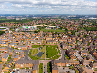 Aerial drone photo over looking the area of Leeds known as Middleton in West Yorkshire, showing the newly built housing estate taken on a sunny part cloudy day.