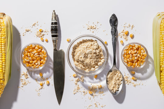 Symmetrical flat lat composition of typical canary gofio on white background.