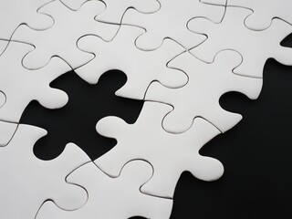 Fototapeta premium Incomplete white jigsaw puzzle with one missing piece on a black background