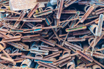Rusted metal scaffolding piled up waiting to be dumped or recycled