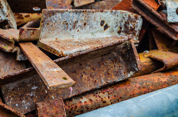 Rusted metal scaffolding piled up waiting to be dumped or recycled