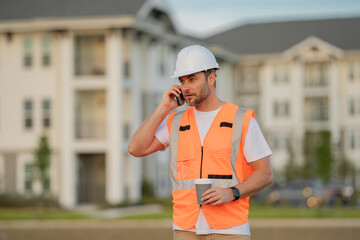 Serious engineer at new home. Construction manager in helmet. Architect at a construction site. Handyman builder in hardhat. Building concept. Builder foreman.