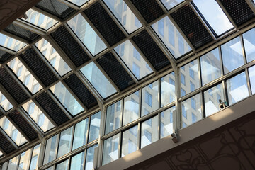 A glass ceiling with a view of a building