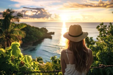 Fototapeta premium Woman admiring sunset over ocean horizon
