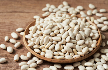 raw white bean in wood bowl on table food background