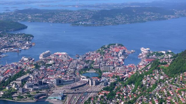 Drone shot from Mount Ulriken in Bergen, Norway on a beautiful summer day. The shot begins with the view of the city centre and pulls back to reveal the summit of the mountain.