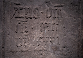 Gorhic font on a stone wall
