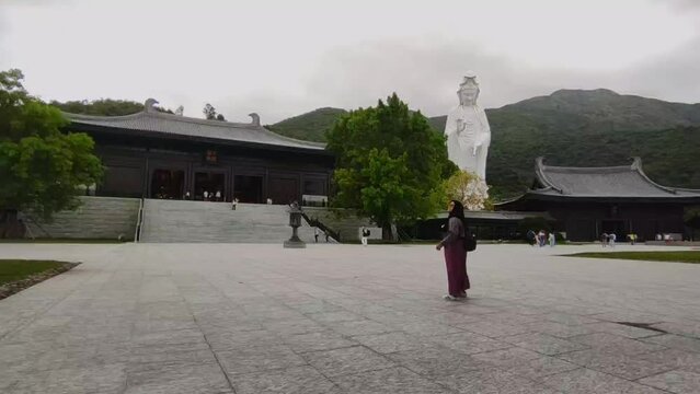 Tourists visiting Tsz Shan Monastery, Hong Kong. Tsz Shan Monastery is a large Buddhist temple located in Tung Tsz, Tai Po District, Hong Kong.