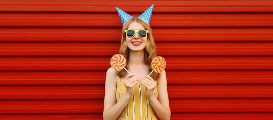 Holiday, celebration. Happy cheerful woman celebrating having fun at a party festive birthday hat