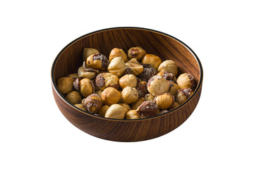 Obraz premium Roasted salted hazelnuts in wooden bowl on isolated white background