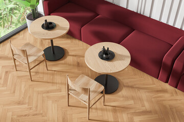 Top view of cafe interior with chairs and sofa in row near panoramic window