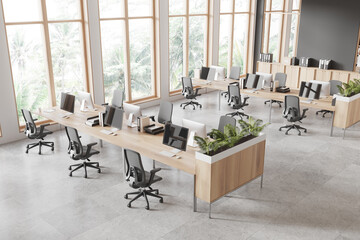 Minimalist coworking interior with pc monitors and chairs near window, top view