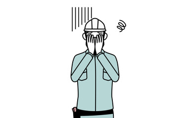 落ち込んで顔を覆うヘルメットと作業着姿の女性技師