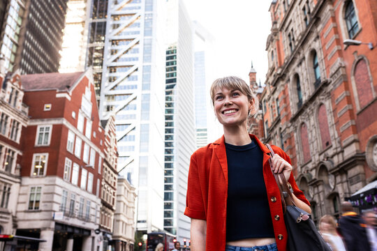 Happy young woman exploring city