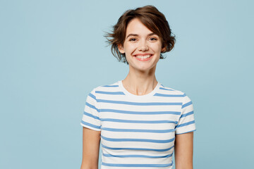 Young smiling happy cheerful fun cool satisfied woman wears striped t-shirt casual clothes looking...