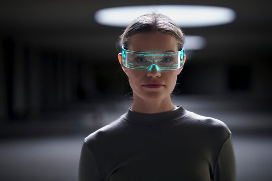 Young woman wearing smart glasses in underground parking