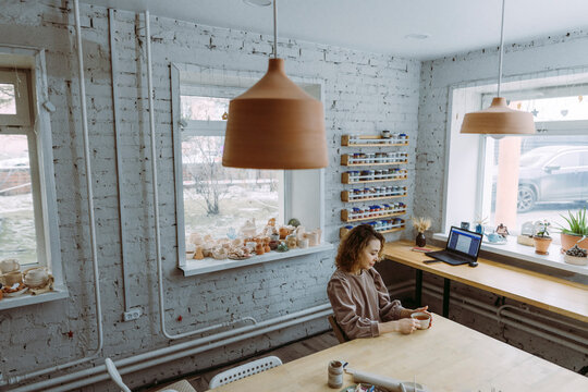Businesswoman having tea at workshop