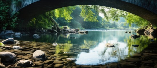 River flowing under a bridge with reflection in water, ideal for copy space image.
