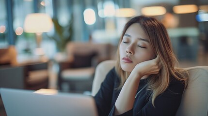 Businesswoman office worker tired sleep take a nap at laptop on sofa in coffee shop cafe Asian female long hair