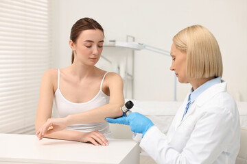 Fototapeta premium Dermatologist with dermatoscope examining patient in clinic