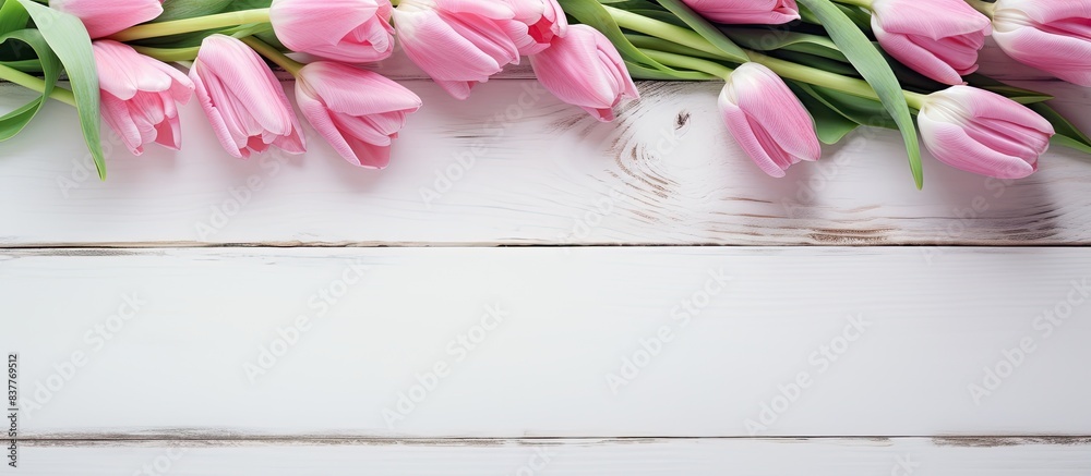 Poster pink tulips displayed on a white wooden table with plenty of copy space image.