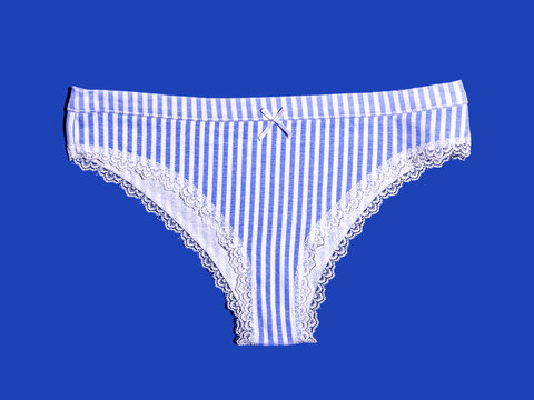 Blue and white striped female underwear on blue background