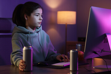 Girl with energy drink playing computer game at home © New Africa