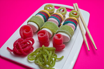Various jelly strips, candies and marshmallows arranged to look like sushi